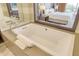 Relaxing bathroom with soaking tub and view of bedroom at 915 Seaside Dr # 312 Weeks 8-9, Sarasota, FL 34242