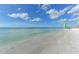 Calm ocean view; sandy beach with paddleboarders and sailboat at 915 Seaside Dr # 312 Weeks 8-9, Sarasota, FL 34242