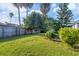Lush backyard with mature trees and green lawn at 6933 43Rd E Ct, Sarasota, FL 34243