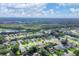 Aerial view of a residential neighborhood showcasing various houses and green spaces at 6933 43Rd E Ct, Sarasota, FL 34243