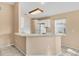 Simple kitchen with light beige cabinets, a breakfast bar, and tile floors at 6933 43Rd E Ct, Sarasota, FL 34243
