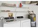 Laundry room with washer, dryer, and shelving for storage at 6933 43Rd E Ct, Sarasota, FL 34243