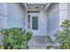 Front entrance with glass panel door and lush landscaping at 6933 43Rd E Ct, Sarasota, FL 34243