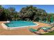 Community pool with lounge chairs and green landscaping at 3810 75Th W St # 116, Bradenton, FL 34209