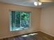 Bright bedroom with large window, ceiling fan, and light wood flooring at 3810 75Th W St # 116, Bradenton, FL 34209