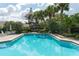 Inviting community pool with lush landscaping and gazebo at 5956 Clubside Dr # 7651, Sarasota, FL 34243
