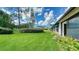 View of the backyard, showcasing a well-maintained lawn and landscaping at 5956 Clubside Dr # 7651, Sarasota, FL 34243
