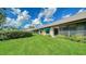 Landscaped backyard with lush green lawn and a row of townhouses at 5956 Clubside Dr # 7651, Sarasota, FL 34243