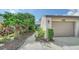 Home exterior with landscaped walkway leading to garage at 5956 Clubside Dr # 7651, Sarasota, FL 34243
