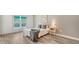 Bedroom with large window, wood-look floors, and built-in shelving at 5956 Clubside Dr # 7651, Sarasota, FL 34243