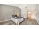 Bright bedroom featuring wood-look floors and ensuite bathroom access at 5956 Clubside Dr # 7651, Sarasota, FL 34243