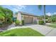 Home exterior showcasing landscaping and two-car garage at 5956 Clubside Dr # 7651, Sarasota, FL 34243