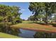 Serene golf course with water and trees at 5956 Clubside Dr # 7651, Sarasota, FL 34243