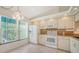 White kitchen with granite countertops and stainless steel appliances at 5956 Clubside Dr # 7651, Sarasota, FL 34243