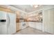 White kitchen with granite countertops and stainless steel appliances at 5956 Clubside Dr # 7651, Sarasota, FL 34243