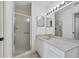 Bathroom with a shower, vanity, and double mirrors at 4640 Tower Hill Ln # 2316, Sarasota, FL 34238