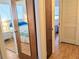 Hallway with mirrored closet doors and access to bedrooms at 5925 Todd St # D-21, Bradenton, FL 34207