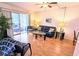 Bright living room featuring hardwood floors, comfy seating, and sliding glass doors to a patio at 5925 Todd St # D-21, Bradenton, FL 34207