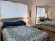 Bedroom with mirrored closet and double bed with coastal bedding at 5925 Todd St # D-21, Bradenton, FL 34207