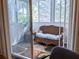 Bright sunroom features wicker furniture and leafy plants, offering a relaxing space at 5925 Todd St # D-21, Bradenton, FL 34207