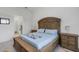 Bright bedroom with wooden bed frame and ensuite bathroom access at 14480 Eagle Branch Dr, Nokomis, FL 34275