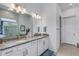 Double vanity bathroom with granite countertop and walk-in shower at 14480 Eagle Branch Dr, Nokomis, FL 34275