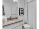 Bathroom with granite countertop, white vanity, and shower at 14480 Eagle Branch Dr, Nokomis, FL 34275