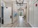 Elegant hallway with hardwood floors and modern light fixtures at 14480 Eagle Branch Dr, Nokomis, FL 34275