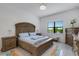 Spacious bedroom with large bed, wood furniture and window views at 14480 Eagle Branch Dr, Nokomis, FL 34275