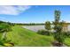 Landscaped yard with a scenic lake view at 14480 Eagle Branch Dr, Nokomis, FL 34275