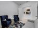 Sitting room with two blue armchairs, a grey sofa, and patterned rug at 14480 Eagle Branch Dr, Nokomis, FL 34275