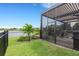 Backyard view showing a screened patio and lake view at 14480 Eagle Branch Dr, Nokomis, FL 34275