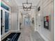 Elegant community hallway with modern light fixtures and wood-look tile flooring at 14480 Eagle Branch Dr, Nokomis, FL 34275
