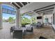 Relaxing outdoor lounge area with comfortable seating and a fireplace at 14480 Eagle Branch Dr, Nokomis, FL 34275