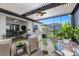 Outdoor kitchen and patio area with seating and ceiling fans at 14480 Eagle Branch Dr, Nokomis, FL 34275