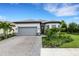 Modern two-car garage home with landscaped yard at 14480 Eagle Branch Dr, Nokomis, FL 34275