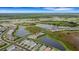Aerial view showing home's location in a community with ponds at 14480 Eagle Branch Dr, Nokomis, FL 34275