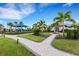 Community playground with shaded play structure, landscaping, and paved pathways at 14480 Eagle Branch Dr, Nokomis, FL 34275
