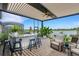 Covered patio features an outdoor kitchen and lake views at 14480 Eagle Branch Dr, Nokomis, FL 34275