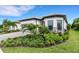 Single-story home with landscaped yard and two-car garage at 14480 Eagle Branch Dr, Nokomis, FL 34275