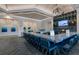 Modern community bar with granite countertop and blue barstools at 14480 Eagle Branch Dr, Nokomis, FL 34275