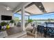 Outdoor patio with covered lanai, seating area, and water views at 14480 Eagle Branch Dr, Nokomis, FL 34275