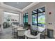 Casual lounge area with a long table and views of the pool at 14480 Eagle Branch Dr, Nokomis, FL 34275