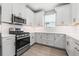 Modern kitchen with stainless steel appliances and white cabinetry at 3118 Tramonto Ct, Bradenton, FL 34211