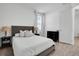 Neutral bedroom with gray upholstered headboard and hardwood-style flooring at 11746 Little River Way, Parrish, FL 34219