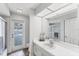 Bright bathroom featuring a white vanity, large mirror, shower, and direct access to the outdoor patio at 5306 19Th W Ave, Bradenton, FL 34209