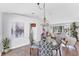Bright dining area featuring a glass-top table, patterned chairs, and a view into the inviting living room at 5306 19Th W Ave, Bradenton, FL 34209