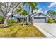 Charming single-story home featuring a well-manicured lawn, lush landscaping, and a two-car garage at 5306 19Th W Ave, Bradenton, FL 34209