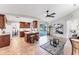 Open-concept kitchen with breakfast bar, wood cabinets, and access to the living room and pool area at 5306 19Th W Ave, Bradenton, FL 34209
