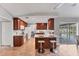 Well-lit kitchen with breakfast bar, wood cabinets, and view of the screened pool area at 5306 19Th W Ave, Bradenton, FL 34209